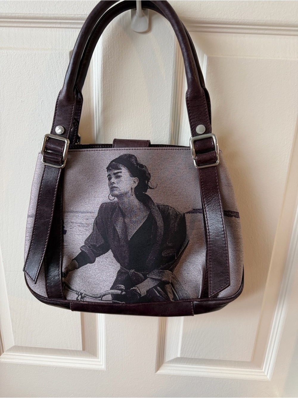 Mairella Burani purple Leather handbag woman riding a bike